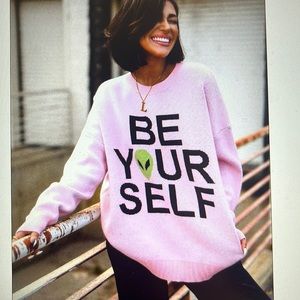 Dressed in LALA oversized “Be Yourself” alien sweatshirt
